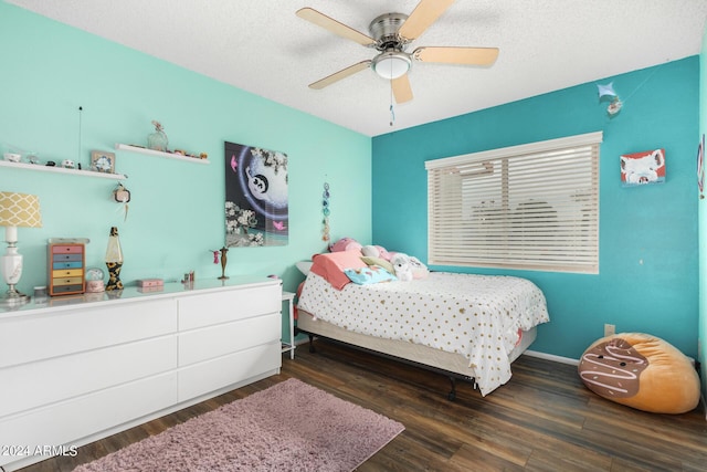 bedroom featuring dark wood-style flooring, ceiling fan, a textured ceiling, and baseboards