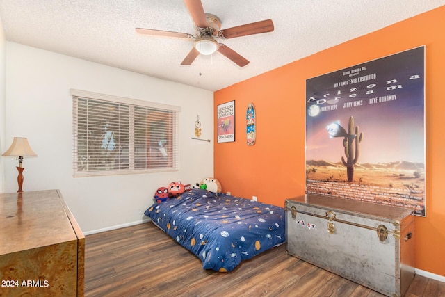 bedroom featuring a ceiling fan, dark wood-style flooring, a textured ceiling, and baseboards