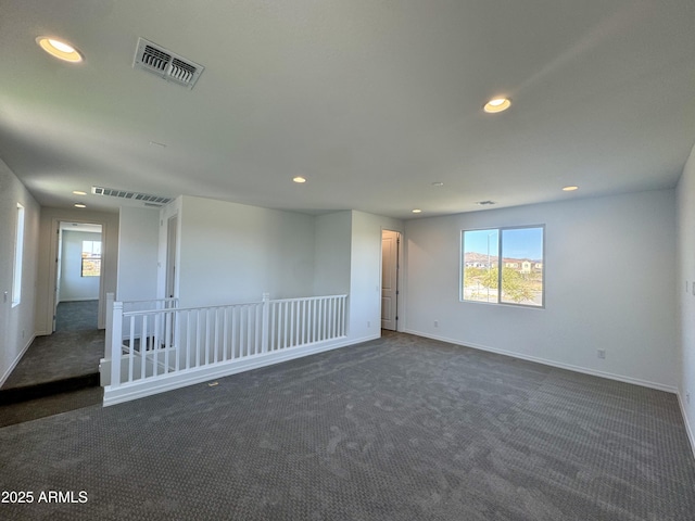 carpeted spare room with visible vents, recessed lighting, and baseboards