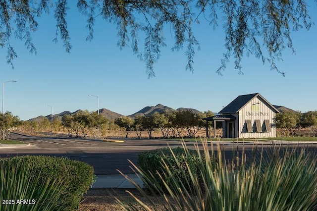 exterior space featuring a mountain view and street lighting