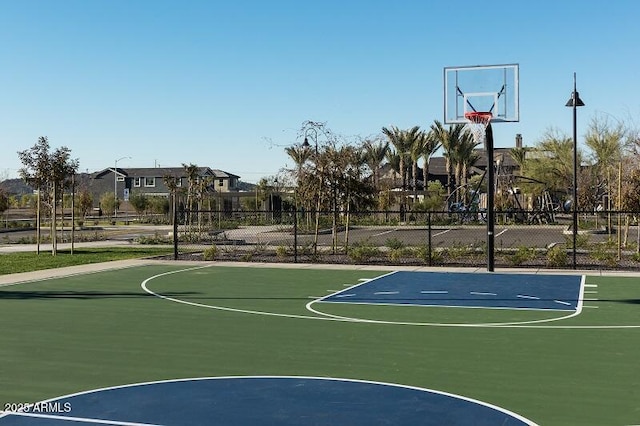 view of basketball court featuring community basketball court and fence