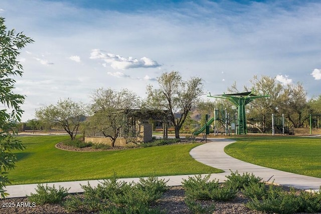 view of home's community featuring playground community and a yard