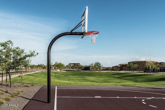 view of basketball court with community basketball court and a lawn