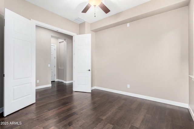 spare room with dark hardwood / wood-style floors and ceiling fan