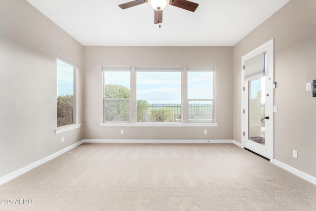 empty room with light carpet and ceiling fan