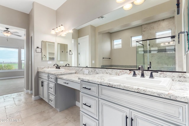 bathroom featuring ceiling fan, vanity, and a shower with door