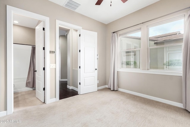 unfurnished bedroom featuring light carpet and ceiling fan