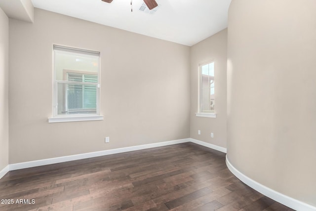 empty room with dark wood-type flooring and ceiling fan