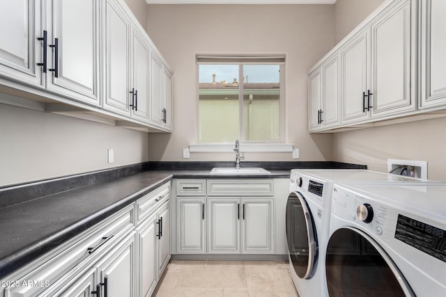 laundry room featuring cabinets, sink, washing machine and dryer, and light tile patterned floors