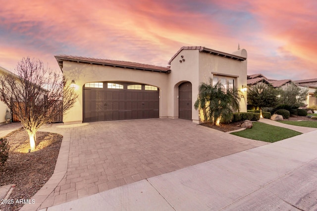 mediterranean / spanish home with a garage