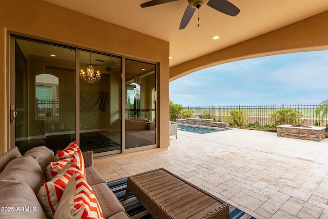 view of patio / terrace with a fenced in pool and ceiling fan