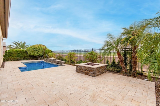 view of swimming pool featuring a fire pit and a patio