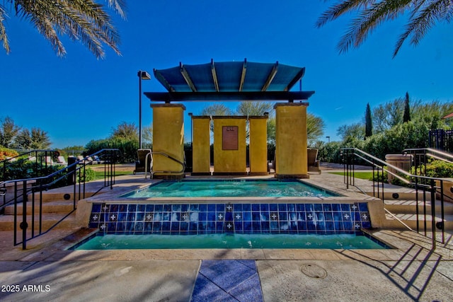 view of pool featuring a jacuzzi and pool water feature