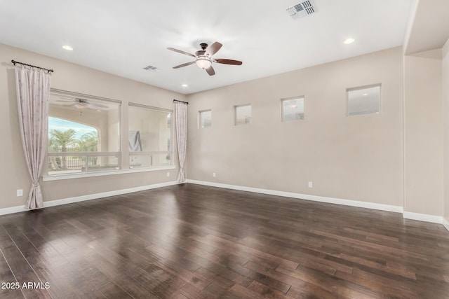 spare room featuring dark wood-type flooring and ceiling fan