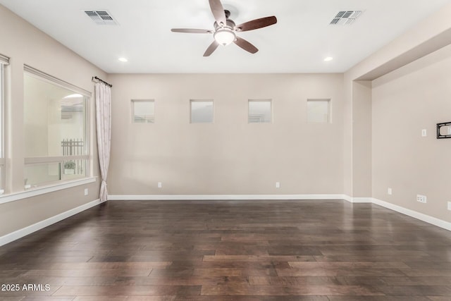 empty room featuring dark wood-type flooring and ceiling fan