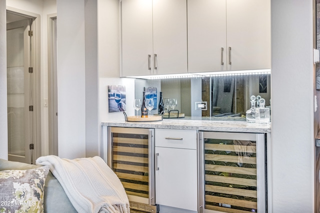 bar with wine cooler and white cabinets