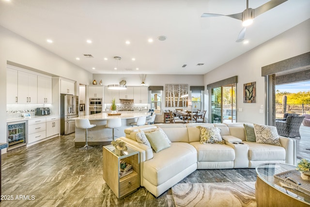 living room with wine cooler and ceiling fan