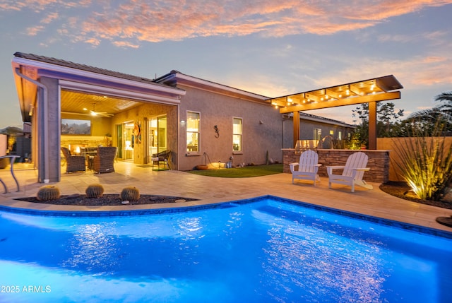 pool at dusk with a patio area