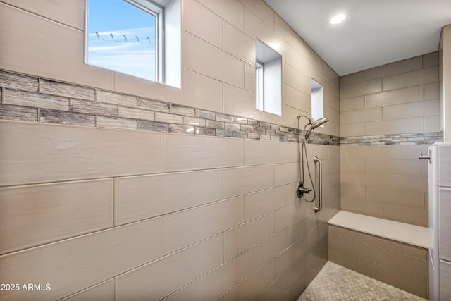 bathroom with a tile shower