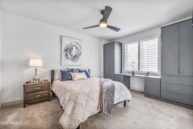 bedroom with light carpet and ceiling fan