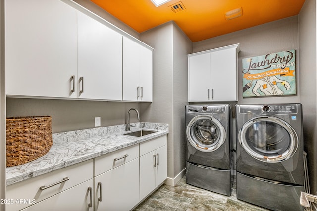 laundry area with sink, cabinets, and washing machine and clothes dryer