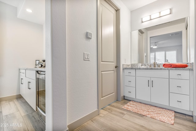 bathroom with vanity, wine cooler, and ceiling fan