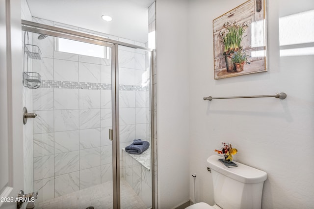 bathroom with an enclosed shower and toilet