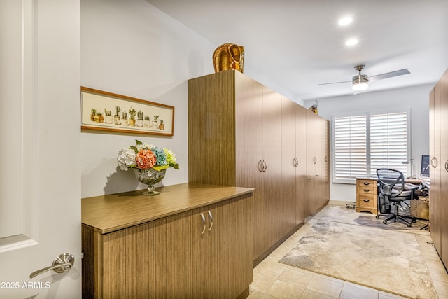 tiled home office featuring ceiling fan