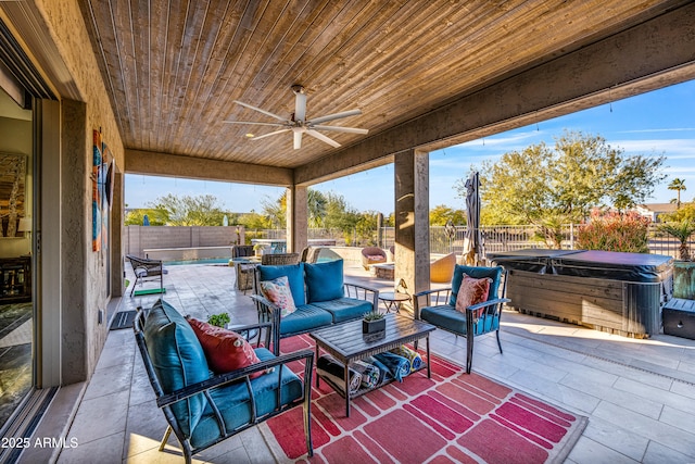 view of patio featuring ceiling fan, a hot tub, and an outdoor hangout area