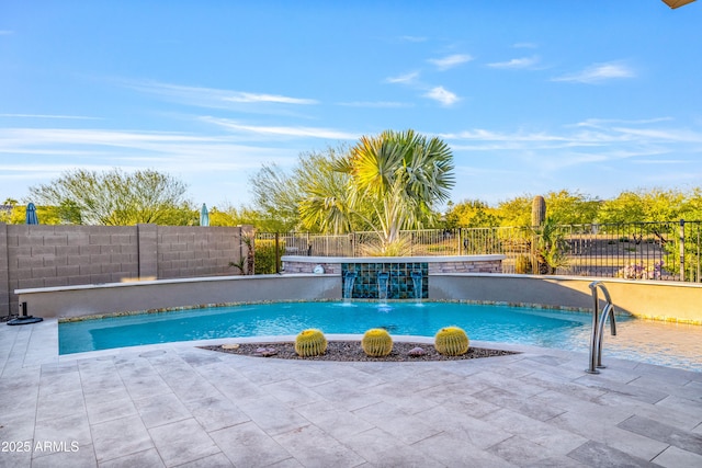 view of pool with a patio area and pool water feature