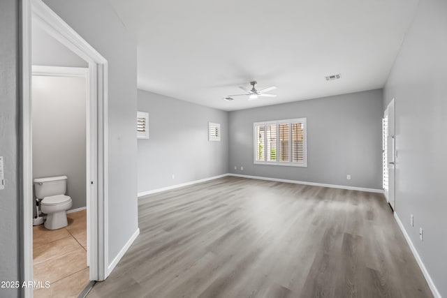 16763 W Magnolia St, Goodyear, AZ 85338 - spare room featuring ceiling fan, wood finished floors, and baseboards