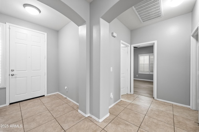 16763 W Magnolia St, Goodyear, AZ 85338 - foyer entrance with arched walkways, tile patterned flooring, and baseboards