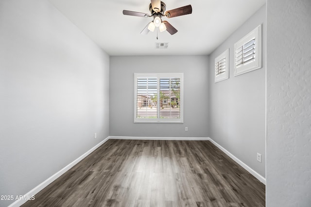 16763 W Magnolia St, Goodyear, AZ 85338 - empty room featuring dark wood finished floors, ceiling fan, and baseboards
