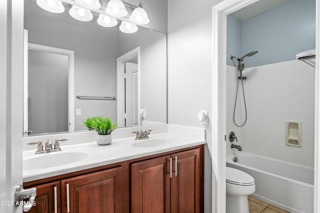 16763 W Magnolia St, Goodyear, AZ 85338 - bathroom with double vanity, toilet, shower / bath combination, and tile patterned flooring