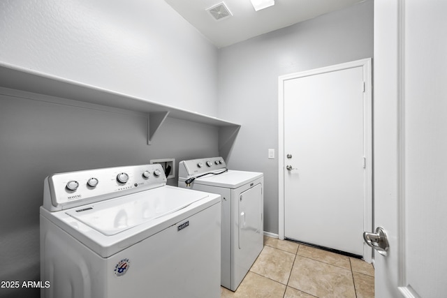16763 W Magnolia St, Goodyear, AZ 85338 - laundry room featuring washing machine and dryer and light tile patterned floors