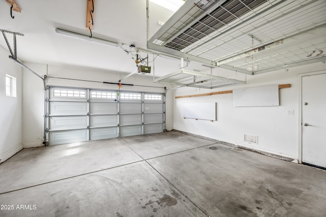 16763 W Magnolia St, Goodyear, AZ 85338 - garage featuring baseboards and a garage door opener
