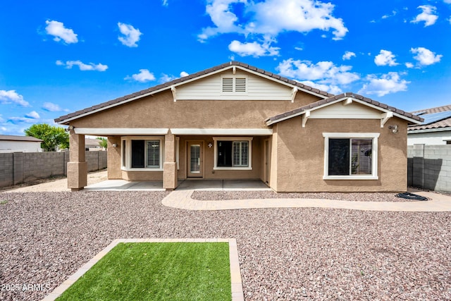 16763 W Magnolia St, Goodyear, AZ 85338 - rear view of property featuring stucco siding, a patio, a fenced backyard, and a tiled roof