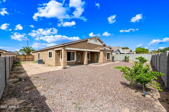 16763 W Magnolia St, Goodyear, AZ 85338 - back of property with stucco siding, a patio, central air condition unit, and a fenced backyard