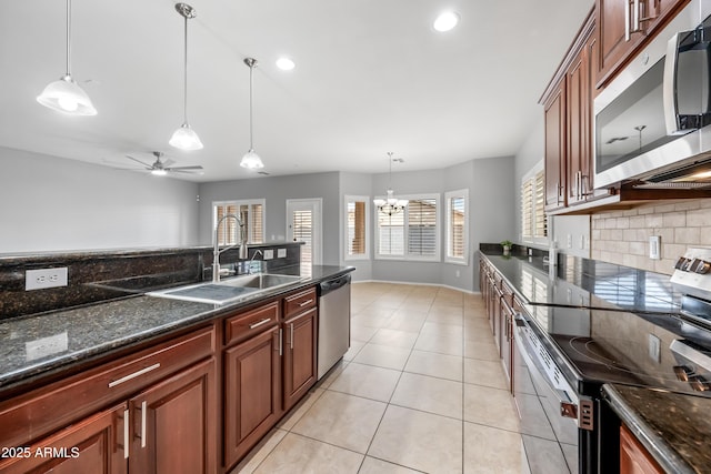 16763 W Magnolia St, Goodyear, AZ 85338 - kitchen with appliances with stainless steel finishes, a sink, tasteful backsplash, a chandelier, and hanging light fixtures