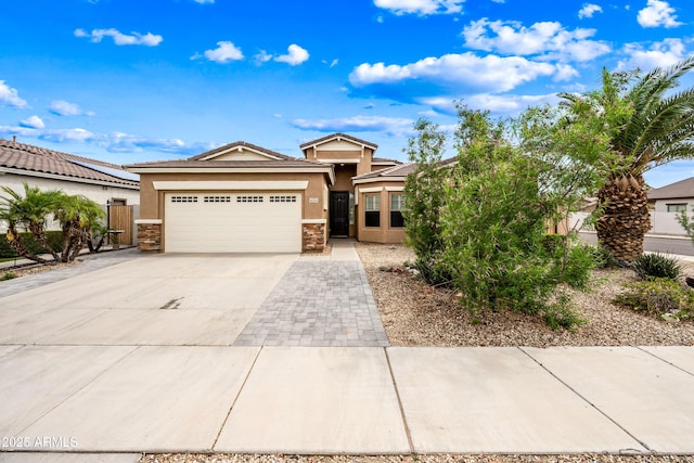 16763 W Magnolia St, Goodyear, AZ 85338 - ranch-style home featuring an attached garage, stucco siding, concrete driveway, and stone siding