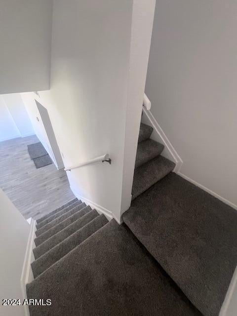 stairs with wood-type flooring