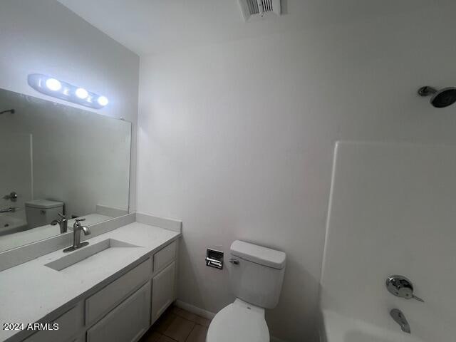 bathroom featuring vanity, toilet, and tile patterned flooring