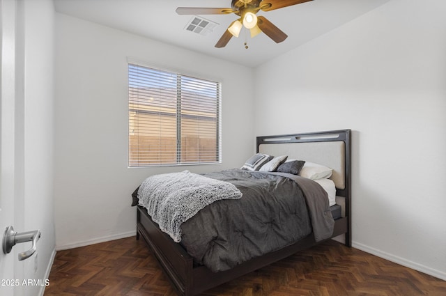 bedroom with ceiling fan and dark parquet floors