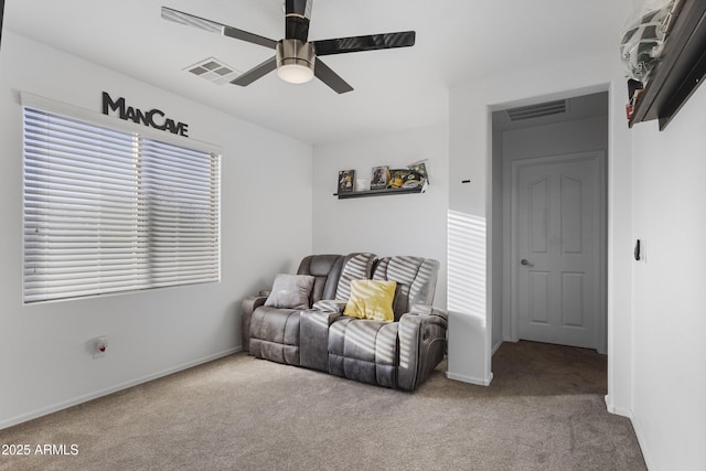 sitting room featuring light carpet and ceiling fan