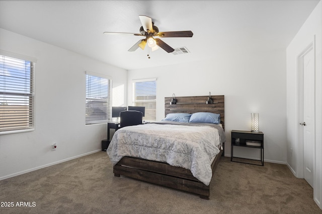 bedroom with ceiling fan and dark carpet