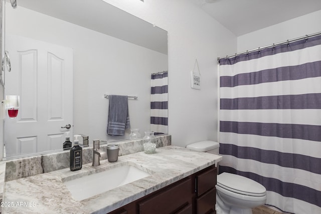 bathroom featuring a shower with shower curtain, vanity, and toilet