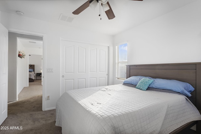 carpeted bedroom featuring ceiling fan and a closet