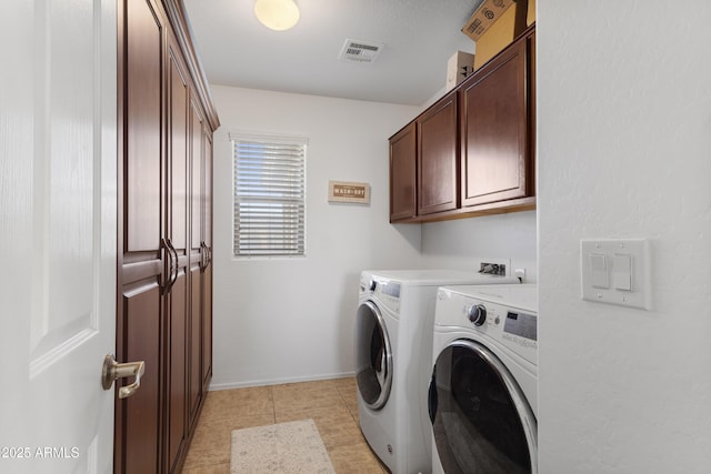 laundry room featuring light tile patterned floors, cabinets, and independent washer and dryer