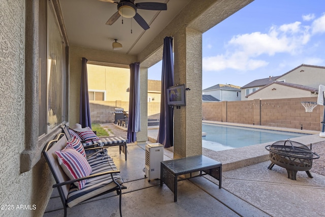 view of pool with an outdoor fire pit, ceiling fan, and a patio area