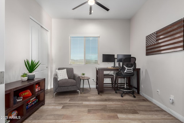 office space featuring ceiling fan, baseboards, and wood finished floors